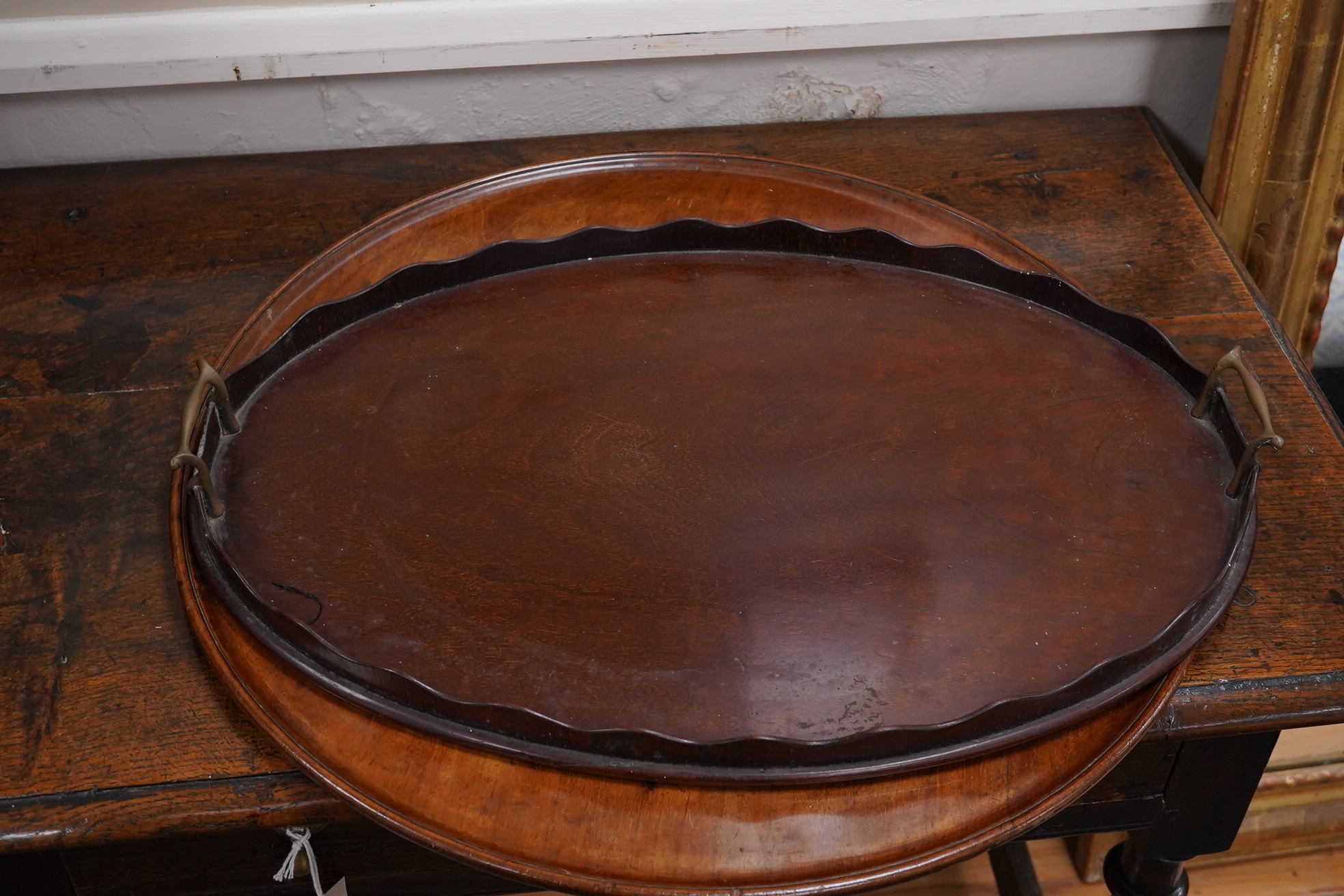 Three various mahogany trays including an Edwardian inlaid and galleried example, largest 61cm wide. Condition - fair